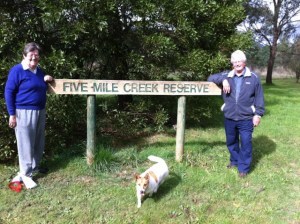 Jo Clancy (Woodend Landcare), Trevor Barker (Upper Campaspe Landcare Network) and Mini the dog at the plant site for Trees for Mum Five Mile Creek Reserve in Woodend.